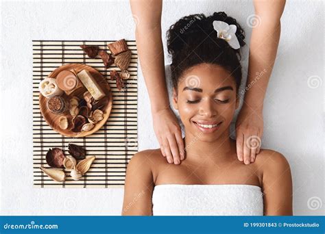 Relaxed African American Woman Enjoying Body Massage At Spa Stock Image