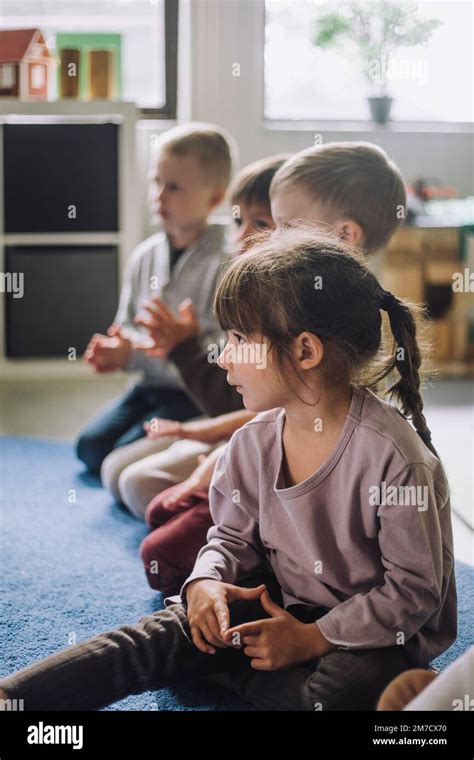Multiracial Children Sitting On Carpet In Kindergarten Stock Photo Alamy