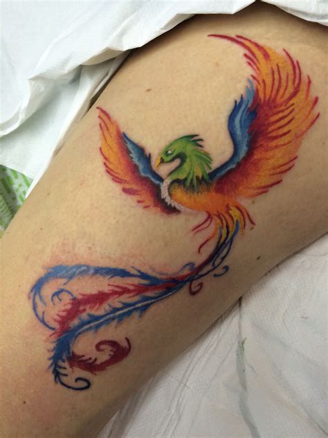This next design covers a section of the thigh and hip. Colourful Phoenix thigh tattoo done by Travis Allen at ...