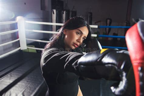 A Beautiful Girl In Boxing Gloves Hits Her Paws In The Ring Woman Is