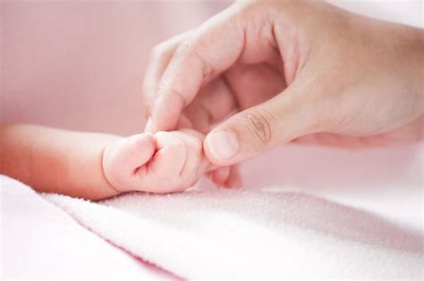Premium Photo Mother Hand Holding Asian Newborn Baby Girl Hand While