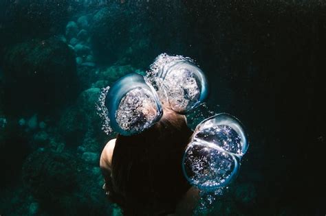 Premium Photo High Angle Of Woman Swimming Underwater In Sea Amidst Bubbles