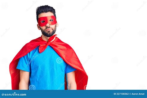 Young Handsome Man With Beard Wearing Super Hero Costume Relaxed With