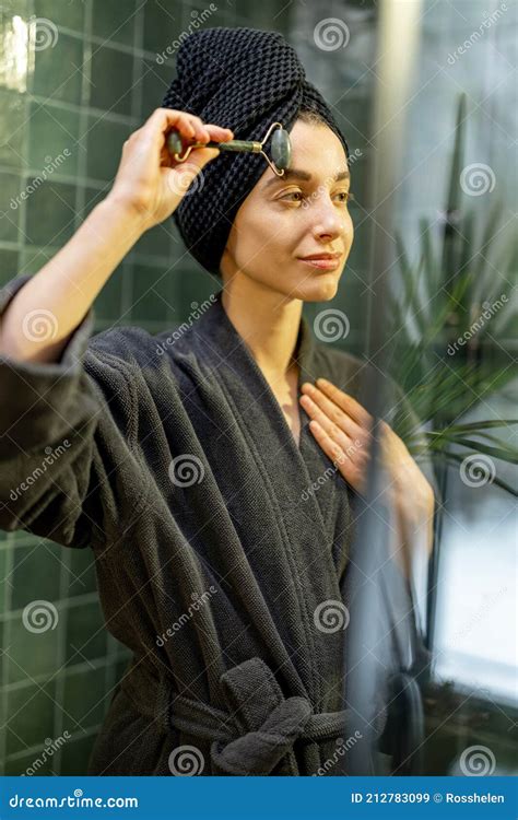 Woman Massaging Her Face In Green Bathroom Stock Image Image Of Care