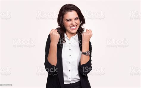 Delighted Businesswoman With Clenched Fists Celebrating Success Stock
