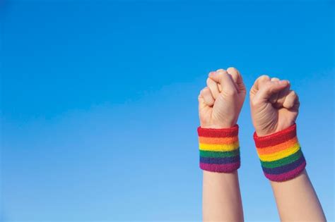 Premium Photo Gay Pride Concept Hand Making A Fist Sign With Gay Pride Lgbt Rainbow Flag Wristband