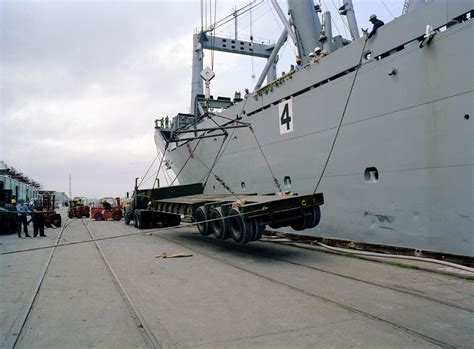 Seabees Offload Heavy Equipment From The Amphibious Cargo Ship Uss