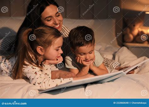 Mother Reading Bedtime Story To Children At Home Stock Photo Image Of