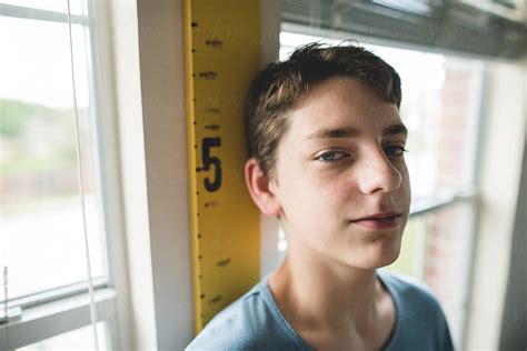 Teen Boy Getting Measured By Stocksy Contributor Courtney Rust
