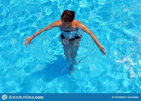Aerial Top View Of Woman In Swimming Pool Water From Above Stock Image