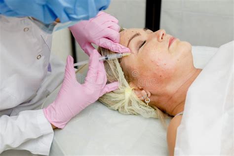 beautician doing facial injection anti aging revitalization cosmetology procedure stock image