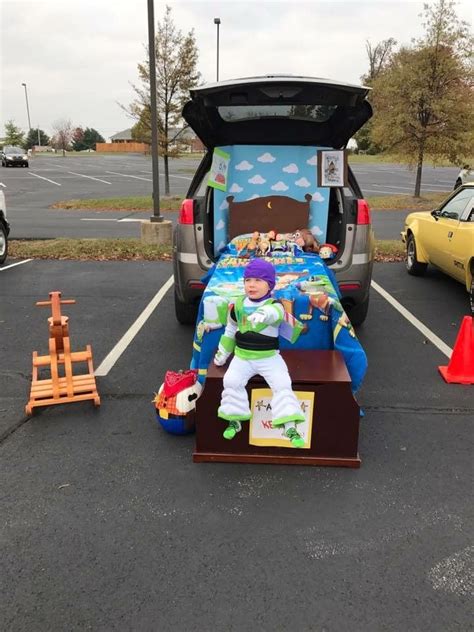 a toy story themed bed in the trunk of a car parked in a parking lot