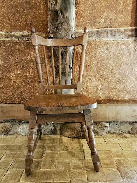 Premium Photo Old Wooden Chair Against Wall At Home
