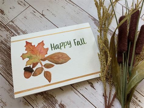 A Happy Fall Card Next To Some Dried Leaves