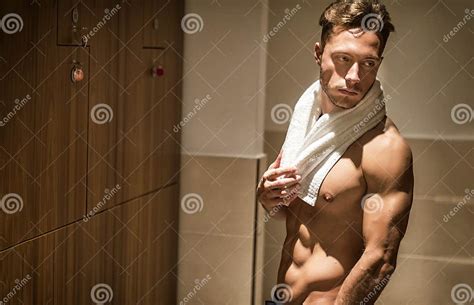 Shirtless Young Male Athlete In Gym Dressing Room With Towel Stock