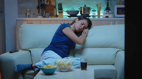 woman sleeping on sofa in front of tv stock footage sbv 338727640 storyblocks