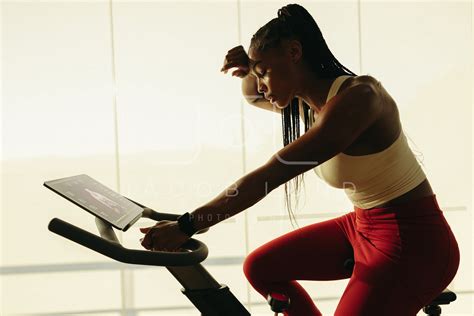 Sweating It Out Young Black Woman Working Out With Cycling App Jacob
