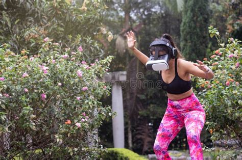 virtual break latin woman takes time to play with vr after outdoor training in a rainy day