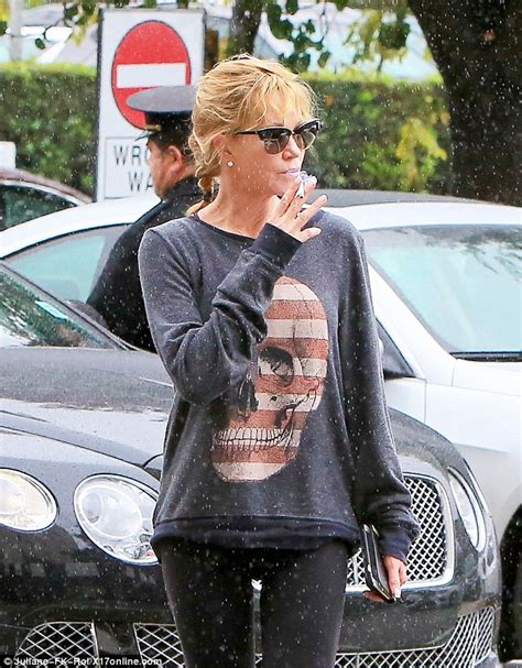Melanie Griffith Puffs On A Cigarette During A Rainy Afternoon In Los