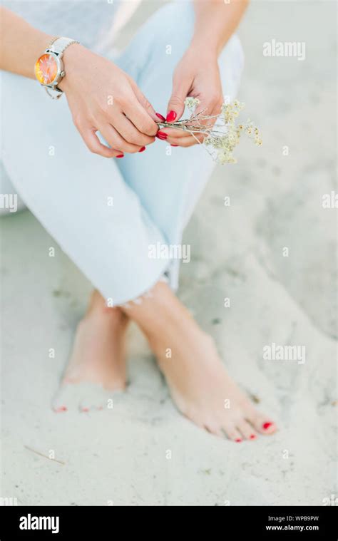 Woman Feet With Red Pedicure In The Beach Sand Cropped Stock Photo Alamy
