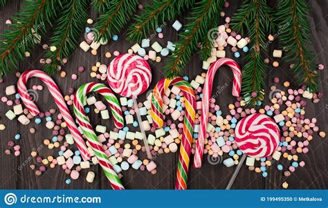 Colorful Candies Lollypops Candy Canes And Fir Tree Branches Stock