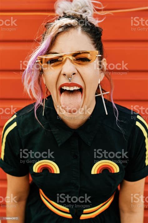 Rebel Alternative Girl With Glasses Shows Tongue To Camera Lifestyle