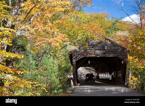 Auto Driving Through Covered Bridge Along The Kancamagus Highway And