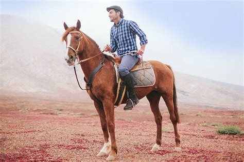 Man Riding A Horse In A Desert Area By Stocksy Contributor Mattia