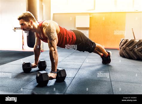 Muscular Man Doing Pushup Exercise With Dumbbell Stock Photo Alamy