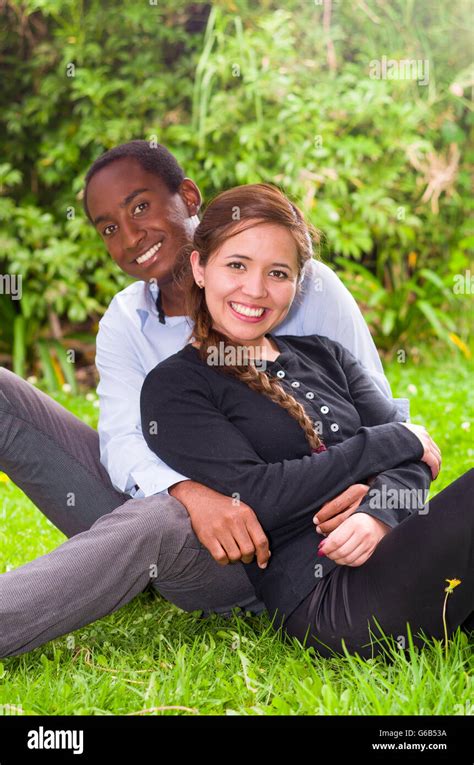 Beautiful Young Interracial Couple In Sitting Garden Environment