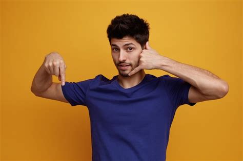 Premium Photo Inspired Young Handsome Man Looking At Camera Doing