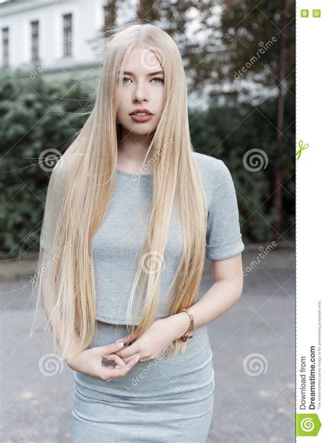 Portrait Of A Beautiful Cute Girl With Long Blond Hair In