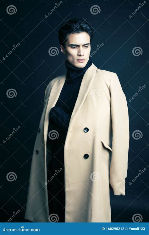 Cool Real Young Man In Coat On Black Background Posing Lifestyle