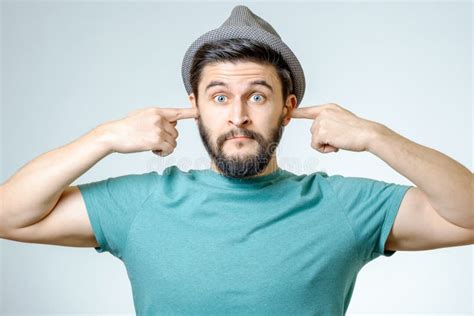 Annoyed Young Man Plugging Ears With Hands Stock Photo Image Of
