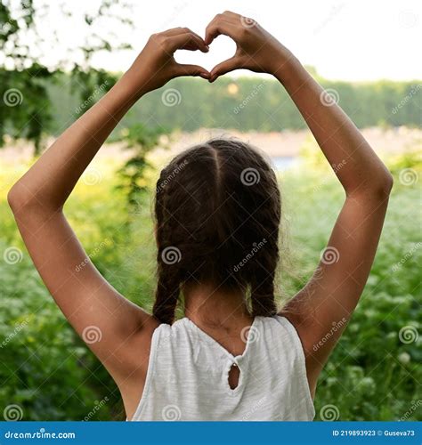 Beautiful And Young Girl Depicts A Heart With Her Hands Above Her Head Stock Image Image Of