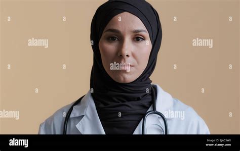islamic arabian woman female doctor cardiologist adviser in hijab talking at camera virtual
