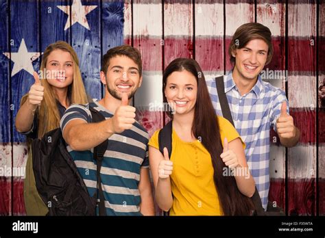 Composite Image Of Happy Students Gesturing Thumbs Up At College