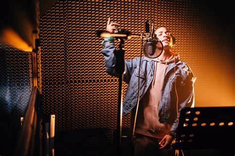 Young Hipster Rap Music Singer Recording Song In Music Studio Stock