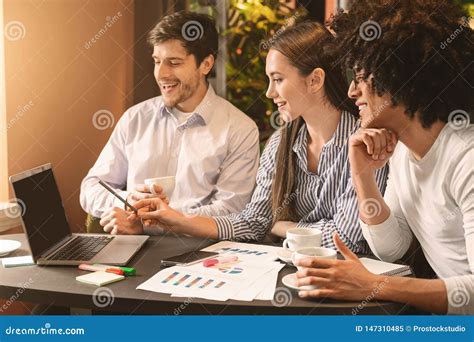 Millennial Partners Discussing Project During Business Lunch Stock