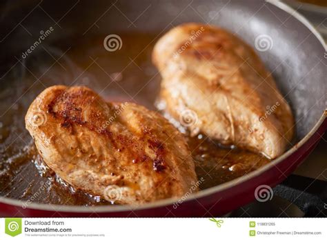 Preheat a non stick skillet (i recommend a well seasoned cast iron) over medium heat on the stovetop and add 1 tbs vegetable oil. Two Chicken Breast Pieces Frying In A Pan. Stock Image ...