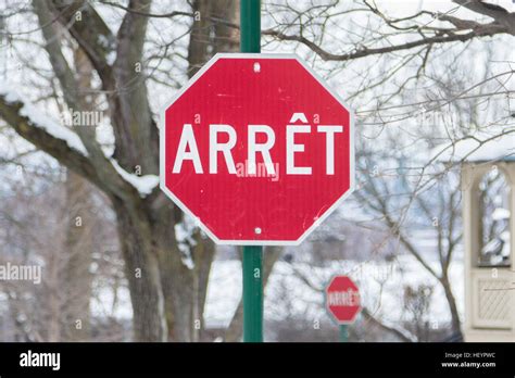 Stop Sign Panneau Arret From Quebec In French In Winter Stock Photo