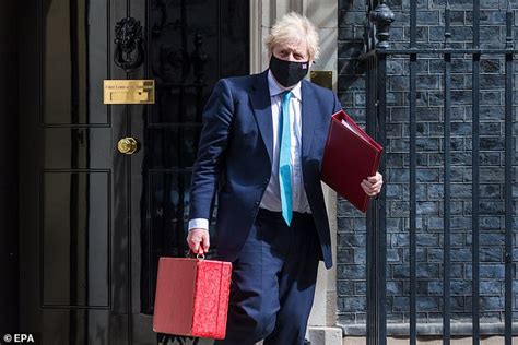 Britain's prime minister boris johnson and carrie johnson pose together in the garden of 10 downing street after their wedding on may 29, 2021. No10 is tight-lipped over Boris Johnson's £535 county ...