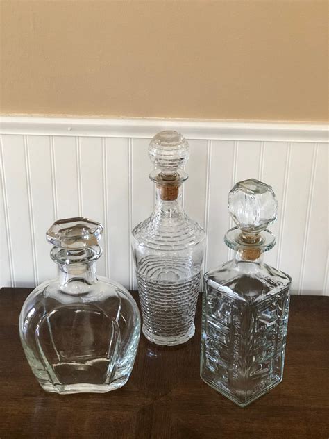 Vintage Glass Liquor Decanters Set Of 3 Etsy Liquor Decanter Set Glass Stopper Liquor Decanter