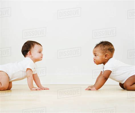 Babies Crawling On Floor Stock Photo Dissolve
