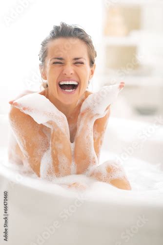 Happy Young Woman Playing With Foam In Bathtub Stockfotos Und