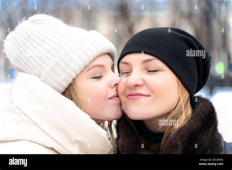 Nice Teenage Girl Hug Kiss In Cheek Happy Young Caucasian Mother Show