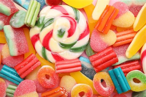 Many Different Jelly Candies And Lollipop As Background Top View Stock