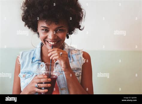 Close Up Shot Of Young African Woman Enjoying A Fresh Fruit Juice