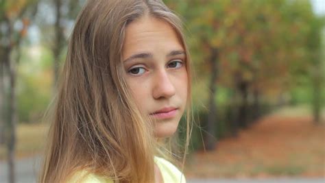Sad Face Teenage Girl Looking At Camera Outdoors Close Up Portrait Of