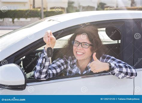 Happy Woman Showing Thumb Up And Driving A New Car Positive Face